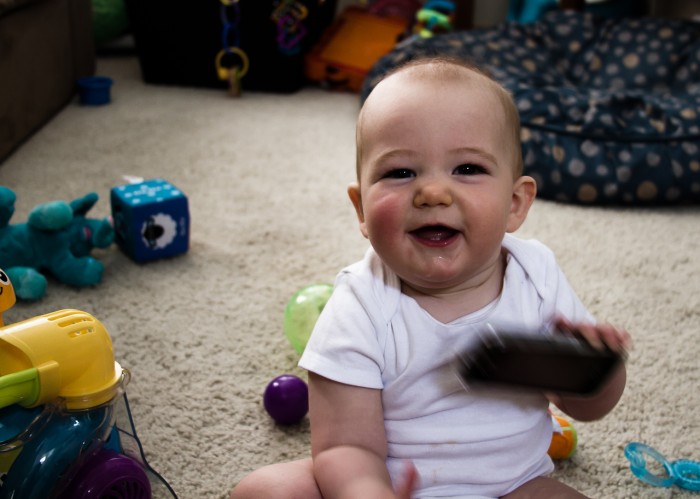Eli Smiling and playing with a phone