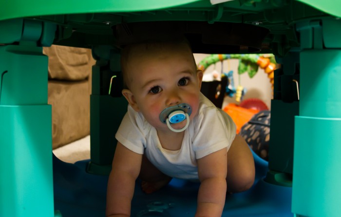 Eli Crawling UNDER his Exersaucer