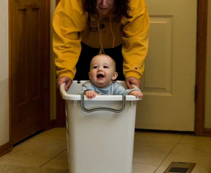 Eli enjoying one of his laundry basket rides